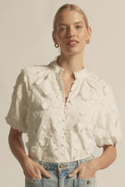 ZOE KRATZMANN | SOLSTICE TOP
crafted in dynamic 3d floral broderie, the solstice top is finished with scalloped lace trims for added charm. a high neck-stand lends structure, while elbow-length blouson sleeves with elasticated cuffs create soft volume. refined and versatile, it’s designed for both everyday wear and occasion dressing.
100% cotton 3D broderie
all-over 3d floral broderie
scalloped lace trims for elevated finish
high neck-stand for structure
elbow-length blouson sleeve with elasticated cuff