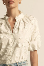 ZOE KRATZMANN | SOLSTICE TOP
crafted in dynamic 3d floral broderie, the solstice top is finished with scalloped lace trims for added charm. a high neck-stand lends structure, while elbow-length blouson sleeves with elasticated cuffs create soft volume. refined and versatile, it’s designed for both everyday wear and occasion dressing.
100% cotton 3D broderie
all-over 3d floral broderie
scalloped lace trims for elevated finish
high neck-stand for structure
elbow-length blouson sleeve with elasticated cuff