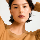 PILGRIM | LIAN RECYCLED BLACK EARRINGS - SILVER PLATED

Unleash your bold side! Add an edgy twist to your style with the statement-ready LIAN earrings from Pilgrim! Crafted in deep black recycled acrylic with an organic, fluid shape that radiates strength and confidence. Perfect for those who love to express their distinctive style with a cool edge. Style them with an oversized blazer and chunky boots for an urban-chic appearance, or pair with a slip dress for a contrasting look. 