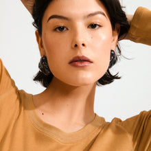PILGRIM | LIAN RECYCLED BLACK EARRINGS - SILVER PLATED

Unleash your bold side! Add an edgy twist to your style with the statement-ready LIAN earrings from Pilgrim! Crafted in deep black recycled acrylic with an organic, fluid shape that radiates strength and confidence. Perfect for those who love to express their distinctive style with a cool edge. Style them with an oversized blazer and chunky boots for an urban-chic appearance, or pair with a slip dress for a contrasting look. 
