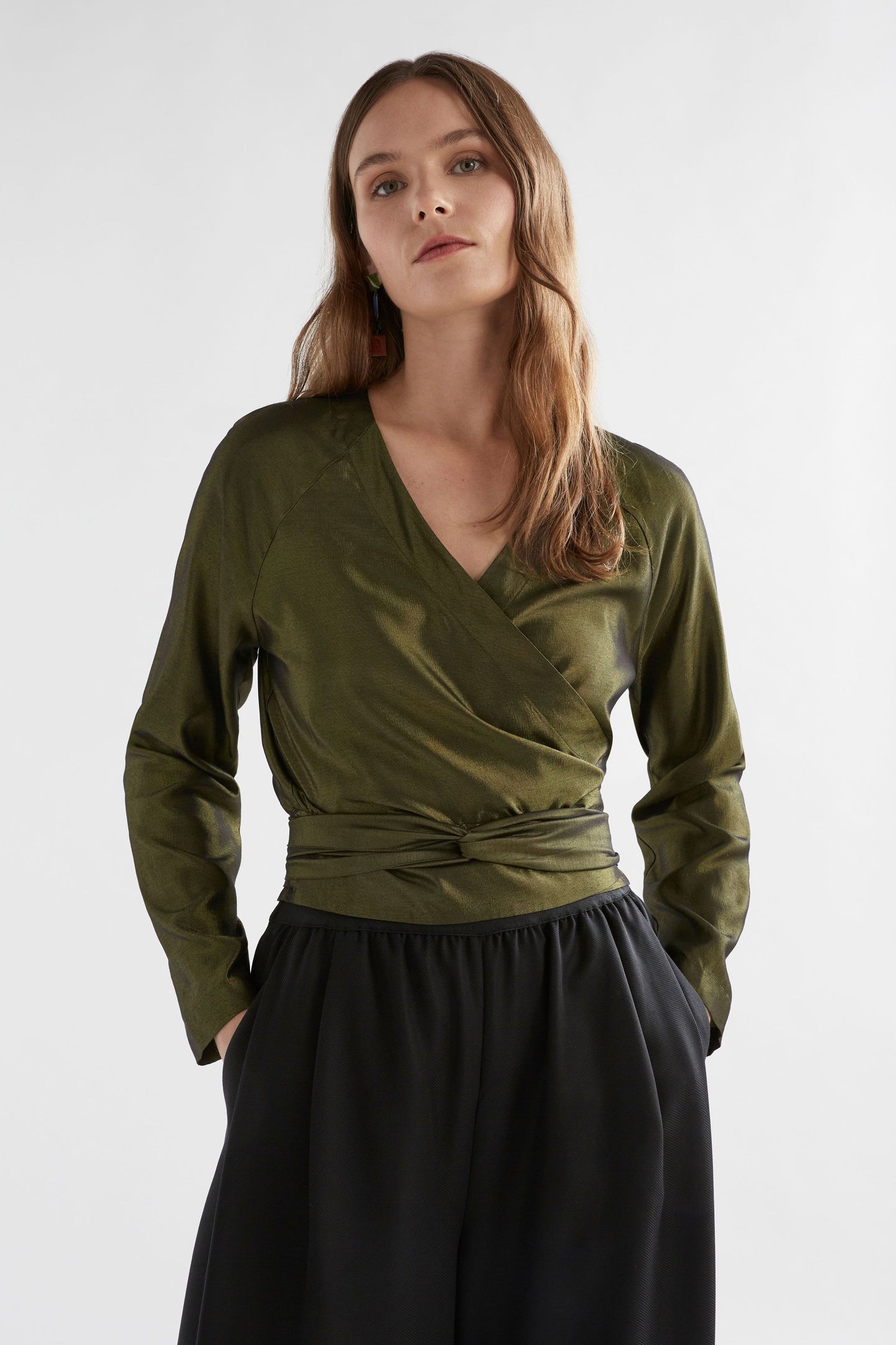 Elevated elegance for the everyday and beyond. The Elk Medjal Top is a sophisticated wrap-style blouse crafted in a striking black and gold palette—designed to shine in evening settings or refined daytime looks. With its flattering wrap silhouette, soft drape, and subtle sheen, it’s the perfect transseasonal piece for effortless dressing.

Made from a luxurious blend of viscose and eco-conscious Ecovero™, the Medjal Top offers breathable comfort with a silky finish. Pair it with tailored trousers or high-wa