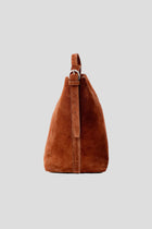 The Esme Suede Tote by Alēo is where luxury meets everyday function. Crafted from a premium mix of soft pebbled calf leather and rich calf suede, this large structured tote adds a sophisticated pop of cranberry and rust to your wardrobe.