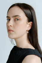 A delicate balance of elegance and shine, the Castel & Co Arina Earrings feature a sleek gold-plated hoop finished with a sparkling diamanté drop. Their refined silhouette catches the light with every movement, making them the perfect piece to elevate both daytime and evening looks.

Material: Stainless steel, Gold plating
Closure Type: Congo
Earring size: 2.2 x 0.4cm
Waterproof and hypoallergenic
Weight: 3g