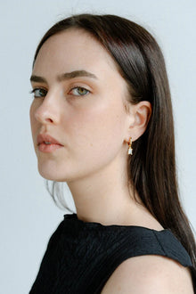 A delicate balance of elegance and shine, the Castel & Co Arina Earrings feature a sleek gold-plated hoop finished with a sparkling diamanté drop. Their refined silhouette catches the light with every movement, making them the perfect piece to elevate both daytime and evening looks.

Material: Stainless steel, Gold plating
Closure Type: Congo
Earring size: 2.2 x 0.4cm
Waterproof and hypoallergenic
Weight: 3g