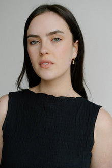 A delicate balance of elegance and shine, the Castel & Co Arina Earrings feature a sleek gold-plated hoop finished with a sparkling diamanté drop. Their refined silhouette catches the light with every movement, making them the perfect piece to elevate both daytime and evening looks.

Material: Stainless steel, Gold plating
Closure Type: Congo
Earring size: 2.2 x 0.4cm
Waterproof and hypoallergenic
Weight: 3g
