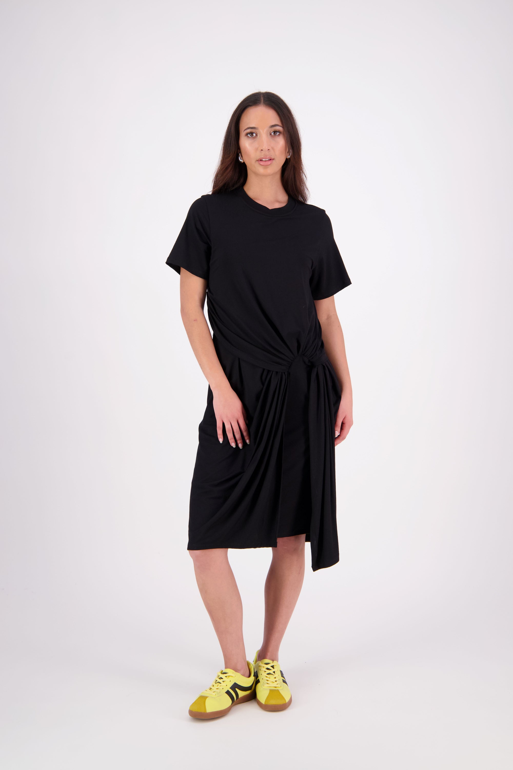 An easy-wear summer staple, 
the N-E-S Ava Knit Dress features a twist pull-through front detail creating a soft, half-moon shape and a subtle asymmetric hem. Designed in a breathable knit with short sleeves and a flattering knee-length cut, it’s the effortless throw-on dress you'll reach for time and time again. Just add slides or sneakers.

Our model is 174cm and wear a XS.

Composition: viscose spandex

Designed and Made in New Zealand