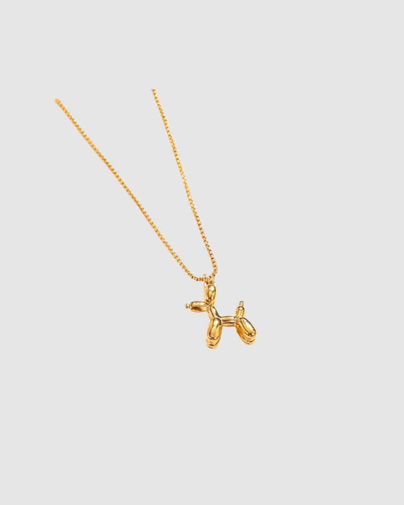 Balloon Dog Necklace by Castel & Co in radiant gold plating, featuring a playful sculptural pendant inspired by a balloon dog design. Suspended on a fine chain for a modern, whimsical statement that can be worn solo or layered. Lobster claw closure with a 40 + 5 cm adjustable length. Crafted from stainless steel, waterproof, hypoallergenic, and weighing 12g.