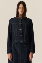 The POL Carsen Denim Jacket is an elevated take on a classic denim jacket. With refined topstitch detailing and a collarless design, we think this just may be the perfect layering piece for Spring.


-Round, collarless neckline.
-Contrast button closure - matches the Carsen Denim skirt and Carsen Pants.
-Full length sleeves - two buttons at the cuff.
-Neater fit through the body.
