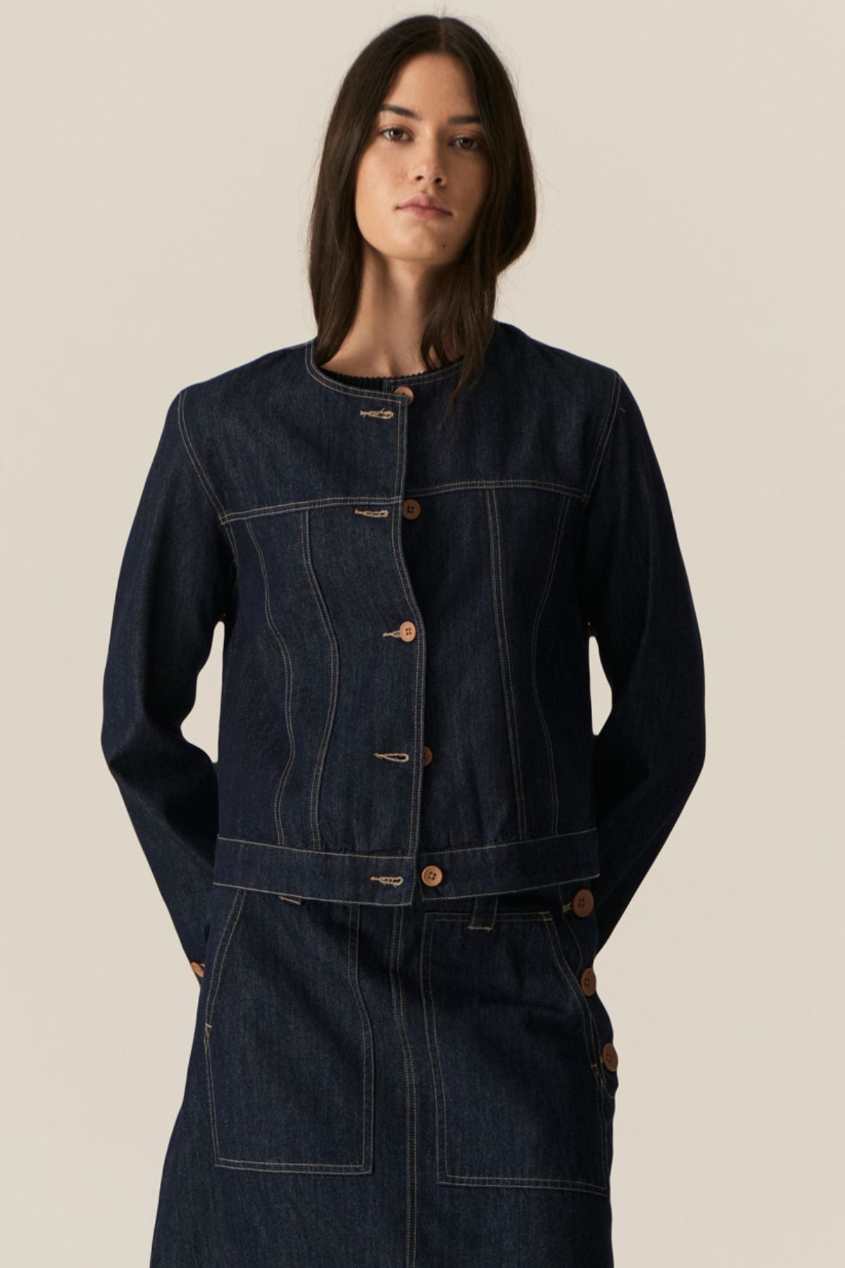 The POL Carsen Denim Jacket is an elevated take on a classic denim jacket. With refined topstitch detailing and a collarless design, we think this just may be the perfect layering piece for Spring.


-Round, collarless neckline.
-Contrast button closure - matches the Carsen Denim skirt and Carsen Pants.
-Full length sleeves - two buttons at the cuff.
-Neater fit through the body.