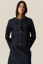 The POL Carsen Denim Jacket is an elevated take on a classic denim jacket. With refined topstitch detailing and a collarless design, we think this just may be the perfect layering piece for Spring.


-Round, collarless neckline.
-Contrast button closure - matches the Carsen Denim skirt and Carsen Pants.
-Full length sleeves - two buttons at the cuff.
-Neater fit through the body.