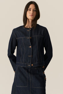 The POL Carsen Denim Jacket is an elevated take on a classic denim jacket. With refined topstitch detailing and a collarless design, we think this just may be the perfect layering piece for Spring.


-Round, collarless neckline.
-Contrast button closure - matches the Carsen Denim skirt and Carsen Pants.
-Full length sleeves - two buttons at the cuff.
-Neater fit through the body.