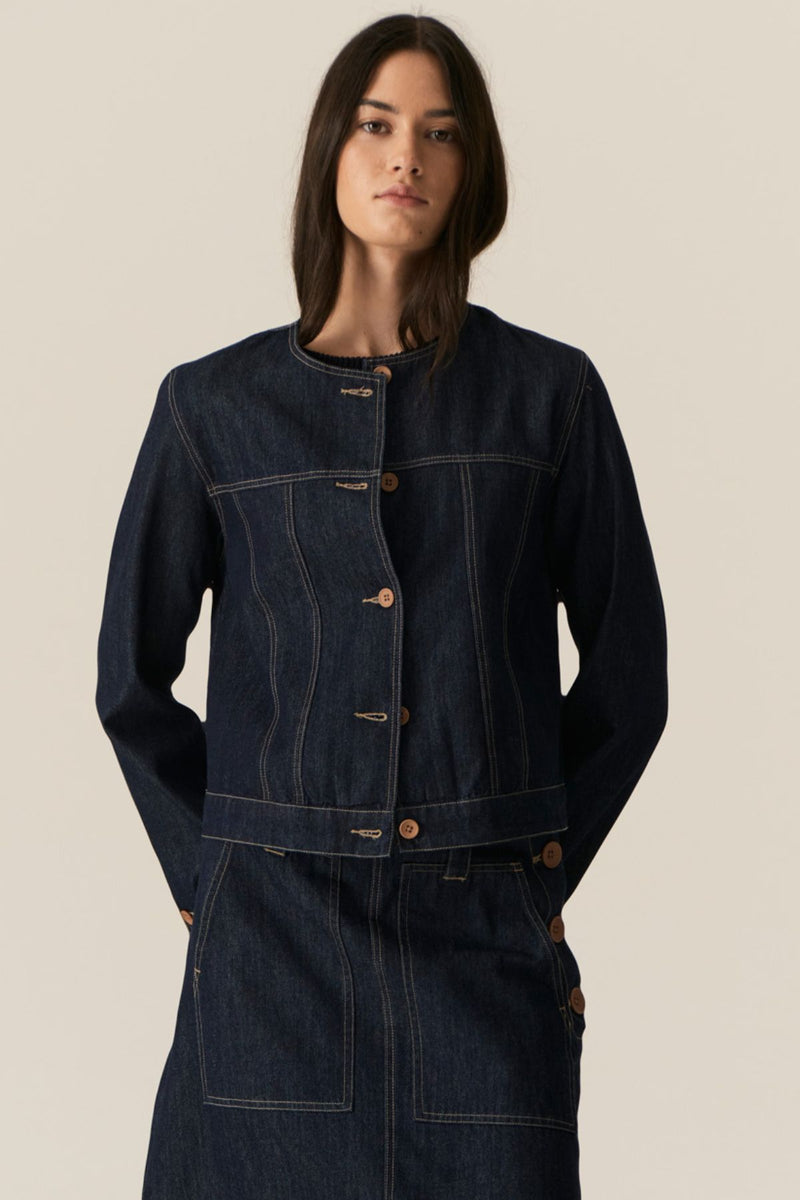 The POL Carsen Denim Jacket is an elevated take on a classic denim jacket. With refined topstitch detailing and a collarless design, we think this just may be the perfect layering piece for Spring.


-Round, collarless neckline.
-Contrast button closure - matches the Carsen Denim skirt and Carsen Pants.
-Full length sleeves - two buttons at the cuff.
-Neater fit through the body.