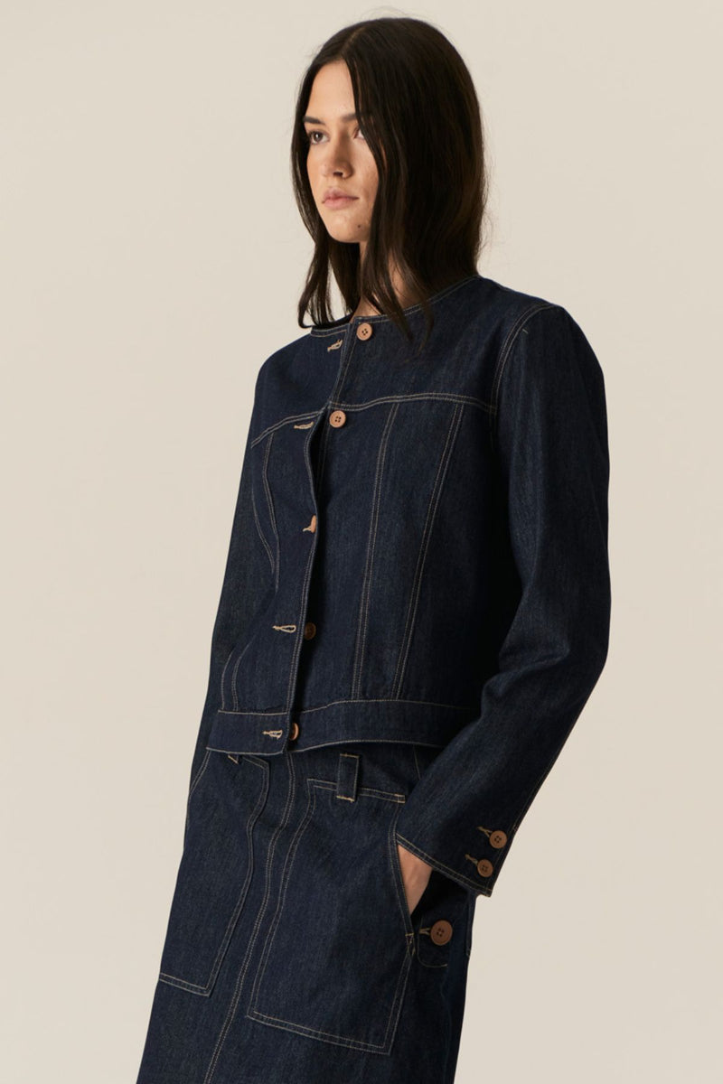 The POL Carsen Denim Jacket is an elevated take on a classic denim jacket. With refined topstitch detailing and a collarless design, we think this just may be the perfect layering piece for Spring.


-Round, collarless neckline.
-Contrast button closure - matches the Carsen Denim skirt and Carsen Pants.
-Full length sleeves - two buttons at the cuff.
-Neater fit through the body.