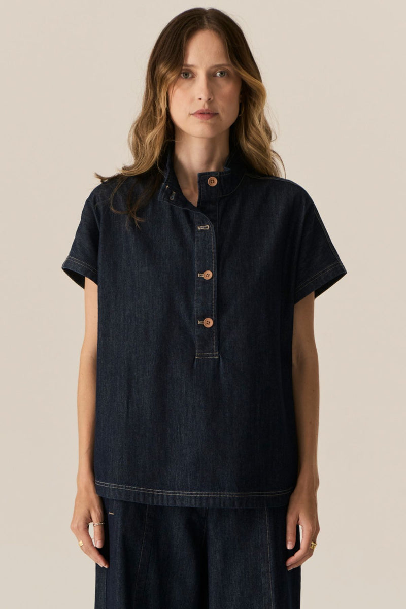 Made from our favourite cotton denim, the POL Carsen Denim Shirt is a new short sleeved style perfect for Spring.

-Slip on style.
-Stand Collar.
-Contrast button closure through to the waist.
-Dropped armholes create a cap sleeve.
-Oversized fit