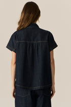 Made from our favourite cotton denim, the POL Carsen Denim Shirt is a new short sleeved style perfect for Spring.

-Slip on style.
-Stand Collar.
-Contrast button closure through to the waist.
-Dropped armholes create a cap sleeve.
-Oversized fit
