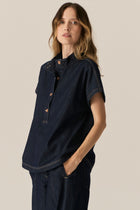 Made from our favourite cotton denim, the POL Carsen Denim Shirt is a new short sleeved style perfect for Spring.

-Slip on style.
-Stand Collar.
-Contrast button closure through to the waist.
-Dropped armholes create a cap sleeve.
-Oversized fit