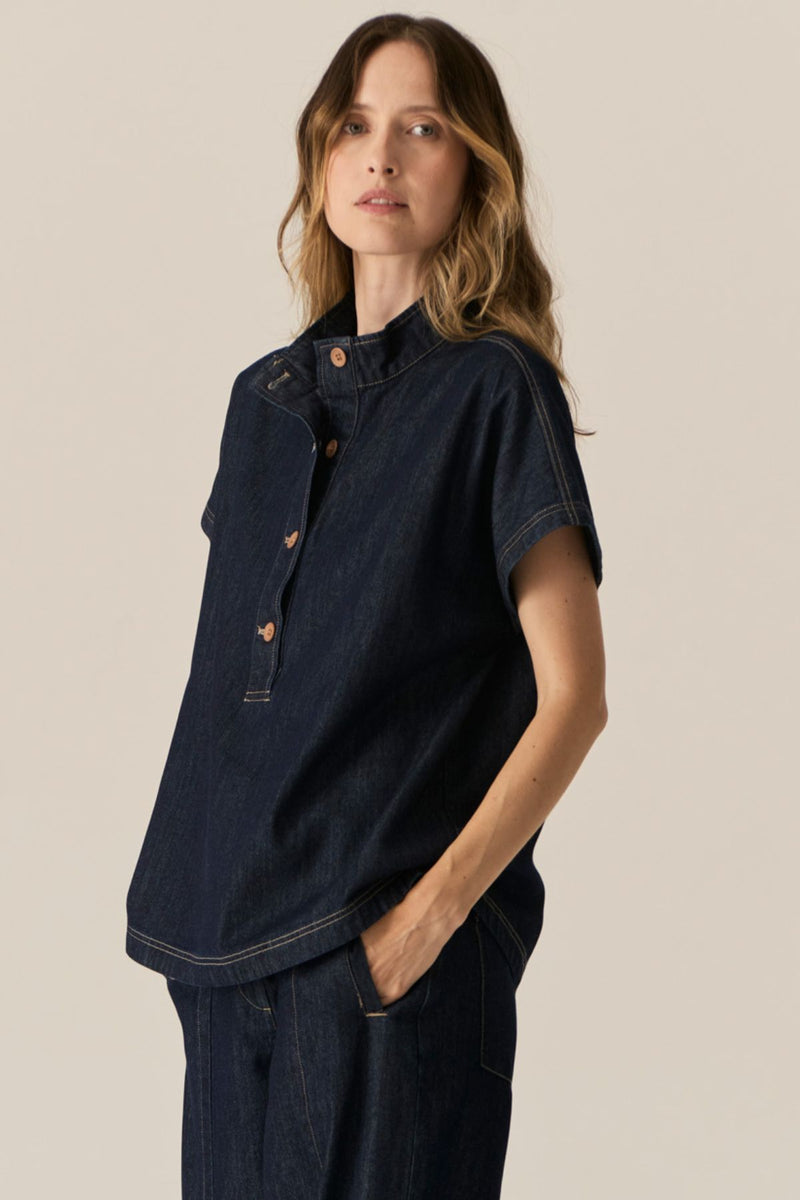 Made from our favourite cotton denim, the POL Carsen Denim Shirt is a new short sleeved style perfect for Spring.

-Slip on style.
-Stand Collar.
-Contrast button closure through to the waist.
-Dropped armholes create a cap sleeve.
-Oversized fit