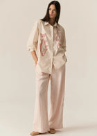 POL CASSIS FISH SHIRT
-Classic shirt collar.
-Button closure through the centre front.
-Gathered detail from yoke at the centre back.
-In-house designed placement fish print on either side at the front.
-Full length sleeves.
-Gathers at the cuffs - two button closure.
-Oversized fit through the body - longline silhouette.
-Hem curves down at the centre back.
-A-line shape.
-Available in Denim/Pebble and Natural/Berry.
100% COTTON