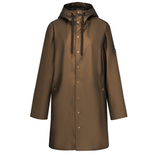 Charlie by Moke lightweight women’s raincoat in Antique Gold, featuring a sleek, streamlined silhouette and soft touch matte TPU finish with 5,000mm waterproof rated fabric, designed for easy layering and everyday wear in light to moderate rain.
