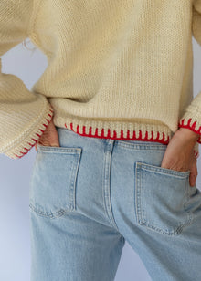 HOBO AND HATCH | Sol Sweater - Chilli - Hand-knitted cream wool sweater crafted from 100% New Zealand wool, featuring playful embroidered chilli motifs and contrasting red blanket-stitch detailing along the hem, neckline, and sleeves. Designed with a relaxed fit, round neckline, and open sleeves for effortless layering or standalone wear. Ethically handcrafted in Nepal alongside local artisans.