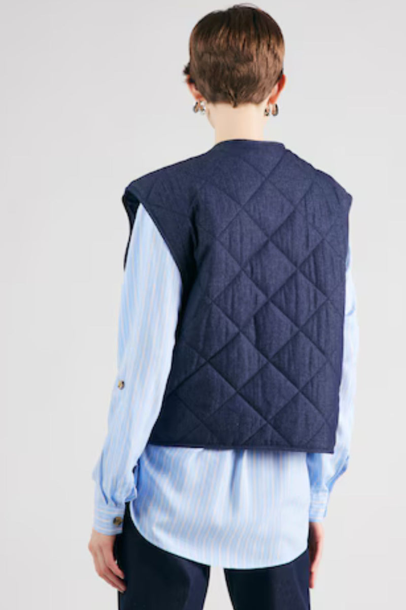 Quilted Vest
Looking for a cute light jacket? Our newest addition to our outerwear collection is here and it's a lightweight MSCH Meika Lysandra cotton vest, in a quilted denim look. It features side pockets, cool front buttons and a round neckline. This can replace a blazer in an indoor outfit or be worn as a spring accessory.

This vest has a boxy fit.

Composition
100% Cotton