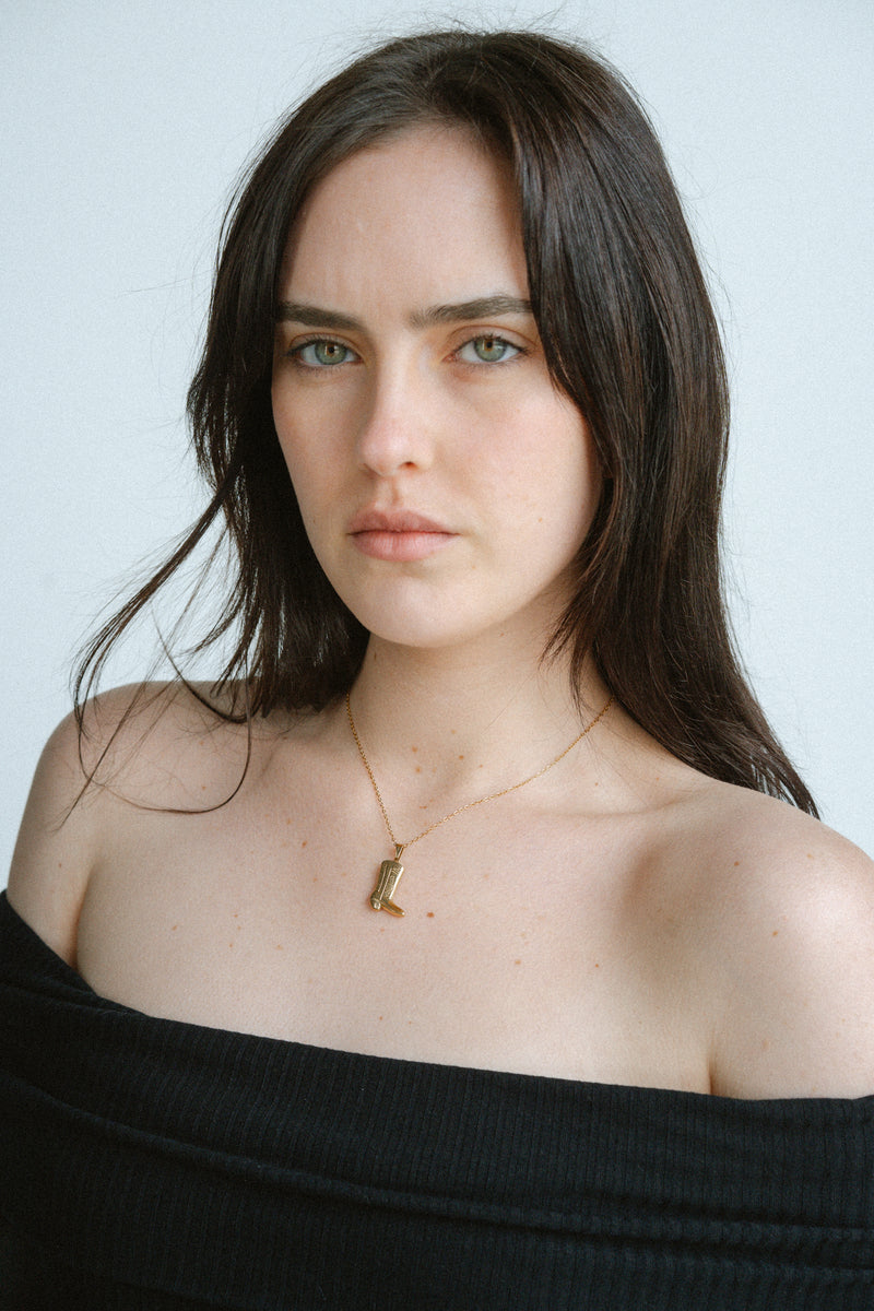 Cowboy Necklace by Castel & Co is a gold-plated stainless steel necklace featuring a detailed cowboy boot pendant on a slim chain. Playful yet stylish design that works well for layering or wearing solo as a statement piece. Necklace length 40 + 5 cm extension, secured with a lobster claw clasp. Lightweight (10g), waterproof, and hypoallergenic.