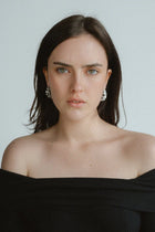 Textured, bold, and effortlessly chic—the Castel & Co Crinkle Earrings in Gold bring a sculptural edge to classic jewellery. Their organic, rippled design reflects light beautifully, creating a statement that feels both modern and timeless. Perfect for adding depth to minimal looks or enhancing an already bold ensemble, these earrings offer a sophisticated yet playful finish to any outfit.

Main material: gold plating, stainless steel
Closure type: stud
Earrings size: 3 x 1,5 cm
Waterproof/ hypoallergenic
