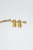 Textured, bold, and effortlessly chic—the Castel & Co Crinkle Earrings in Gold bring a sculptural edge to classic jewellery. Their organic, rippled design reflects light beautifully, creating a statement that feels both modern and timeless. Perfect for adding depth to minimal looks or enhancing an already bold ensemble, these earrings offer a sophisticated yet playful finish to any outfit.

Main material: gold plating, stainless steel
Closure type: stud
Earrings size: 3 x 1,5 cm
Waterproof/ hypoallergenic