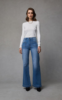 Indy Rodeo Wide Leg Jean by Dricoper in rodeo-blue stretch denim, featuring a high-rise waist, relaxed wide-leg silhouette, and statement patch pockets. Made from 99% cotton and 1% elastane for comfortable stretch. Model is 176cm tall and wears a size 8/Small.