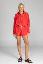 Elevate your style with this must-have BLAK Defiant shirt! Made from a striking red with white pinstripe high quality tencel linen, its relaxed fit and timeless details will make you feel effortlessly cool and infinitely chic. Featuring a drop shoulder, an inverted box pleat in the back, working sleeve cuffs, and a scooped hem, it's a true classic that will fast become your go to shirt.