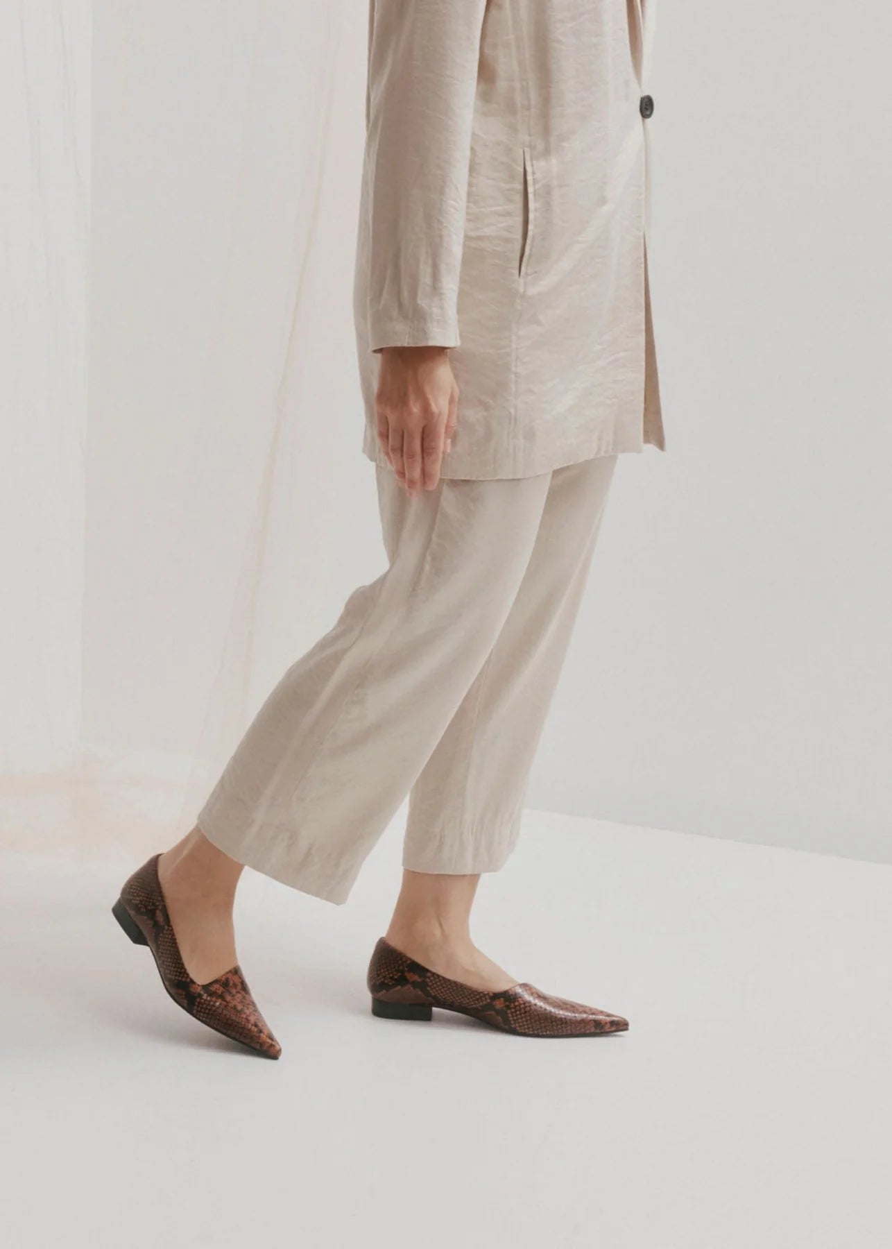 CHAOS &amp; HARMONY | DYNASTY FLAT
The DYNASTY FLAT in Coco Snake is a striking embossed pointed flat in deep chocolate and black tones. With an angled upper and elegant profile, this flat brings texture and edge to both office and off-duty outfits.
Coco snake embossed leather pointed flat
Soft leather lined
Black stack heel / Black rubber outsole
20mm / 0.78 inch heel
Smaller fit - if you are a half size, please size up
