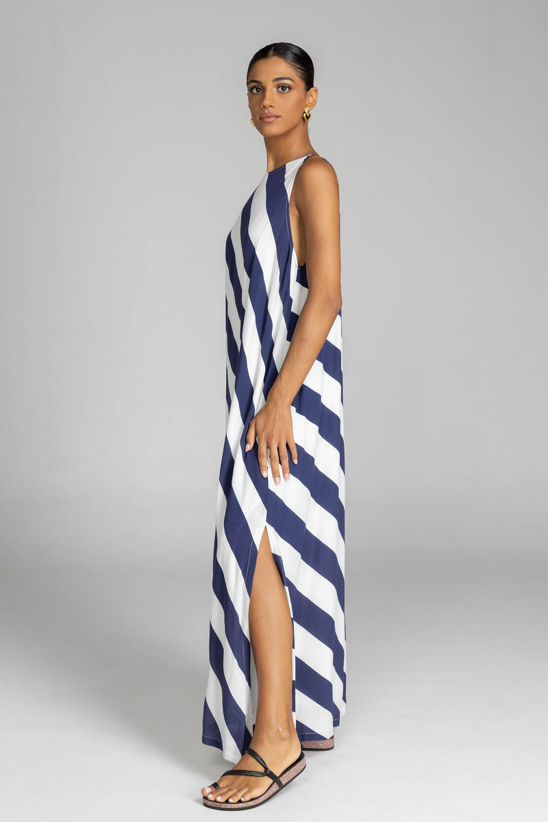 The distinguished BLAK Finally Here Stripe Dress presents our signature silhouette in premium rayon viscose with an elegant navy and white diagonal stripe pattern, featuring a refined high neckline and sleeveless construction. Thoughtful details include a discreet back keyhole with button closure and precise side splits, creating a versatile silhouette that accommodates diverse body types with sophisticated ease.

Fabric composition - Rayon viscose