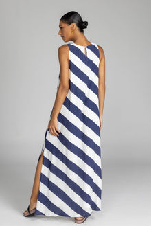The distinguished BLAK Finally Here Stripe Dress presents our signature silhouette in premium rayon viscose with an elegant navy and white diagonal stripe pattern, featuring a refined high neckline and sleeveless construction. Thoughtful details include a discreet back keyhole with button closure and precise side splits, creating a versatile silhouette that accommodates diverse body types with sophisticated ease.

Fabric composition - Rayon viscose