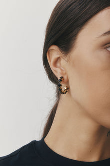Freya Earrings by Castel & Co are gold-plated stainless steel hoop earrings featuring sparkling cubic zirconia accents for a refined, radiant finish. Designed in a modern circular silhouette that catches the light from every angle, balancing elegance with contemporary style. Measuring 3 x 3 cm with a secure stud closure. Lightweight (5g), waterproof, and hypoallergenic.