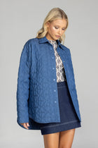 Meet the Blak Frozen Embrace Jacket in denim blue, a premium piece featuring distinctive heart quilting that instantly elevates your style. Crafted from quality cotton with a flattering relaxed fit and convenient dome closures. The trendy drop shoulders and hidden pockets add both fashion appeal and functionality. Expertly finished with bound edges and a curved hem—this versatile essential works for any occasion, making it your smartest wardrobe investment this season.

Fabric composition - Quilted Poly