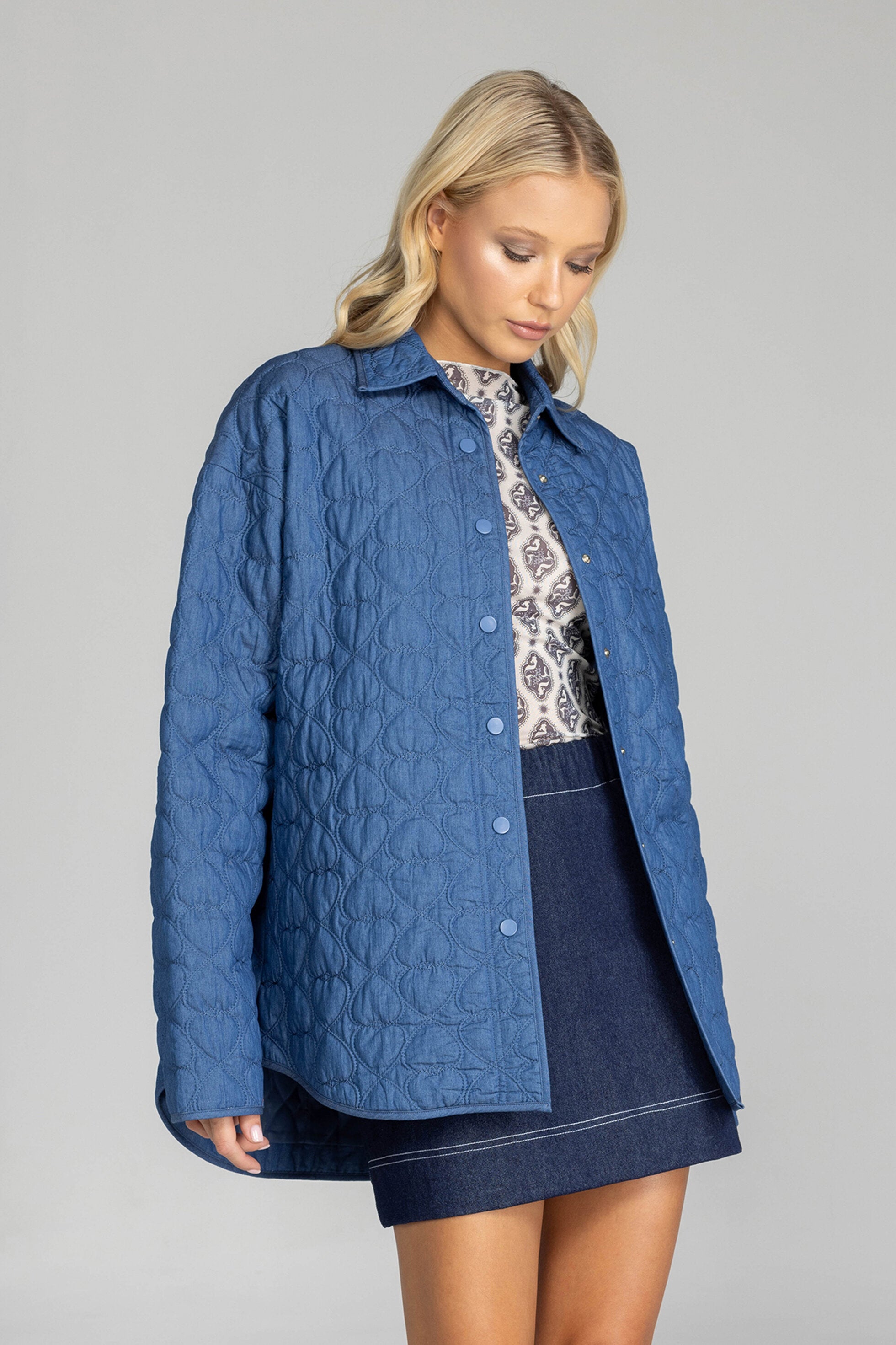 Meet the Blak Frozen Embrace Jacket in denim blue, a premium piece featuring distinctive heart quilting that instantly elevates your style. Crafted from quality cotton with a flattering relaxed fit and convenient dome closures. The trendy drop shoulders and hidden pockets add both fashion appeal and functionality. Expertly finished with bound edges and a curved hem—this versatile essential works for any occasion, making it your smartest wardrobe investment this season.

Fabric composition - Quilted Poly