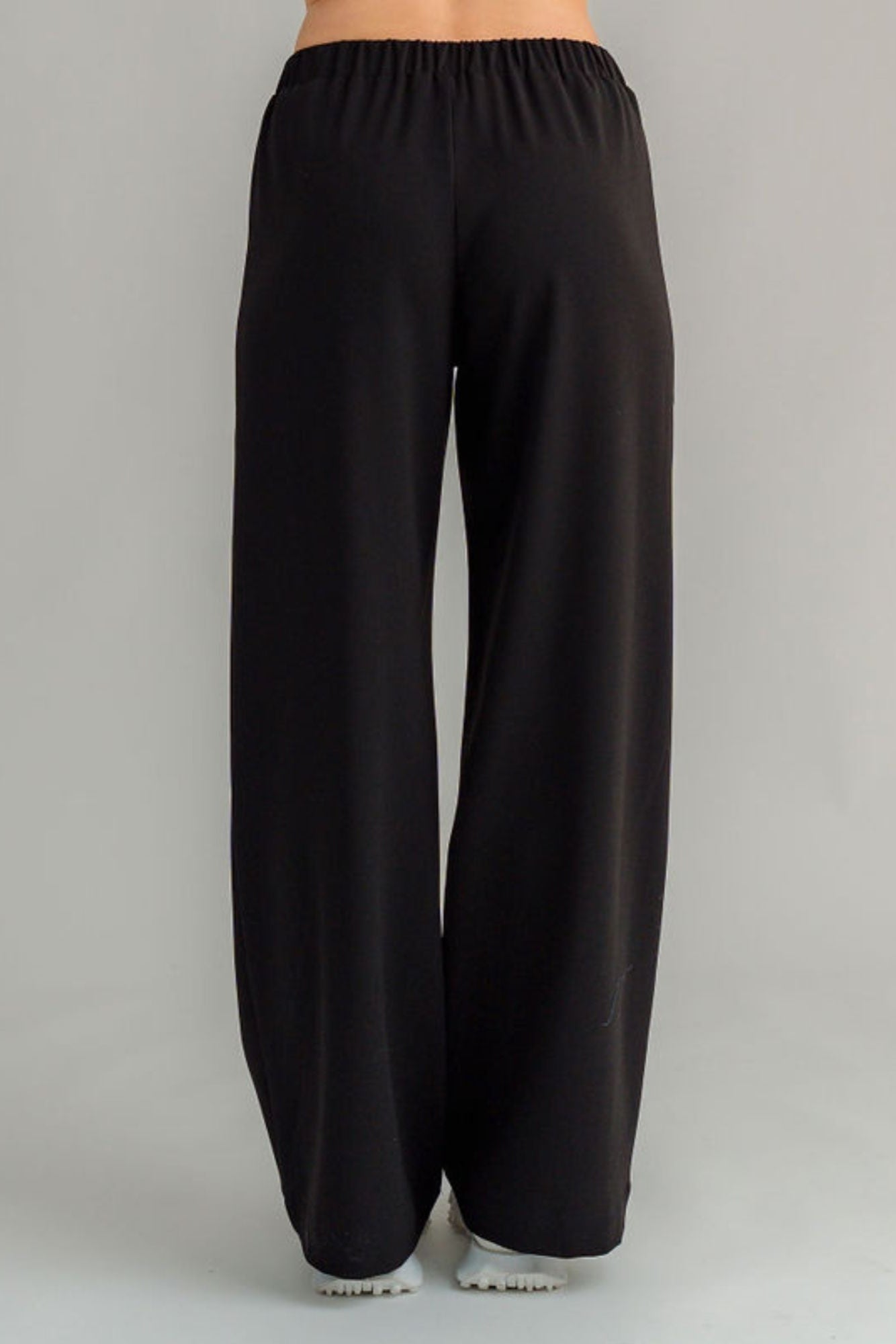 The NES Ginnie Pant is a stylish update to our top-selling Gin Pants, now featuring a pin stitch pleat down the front legs for an elongated, flattering silhouette. With a classic cut that’s easy to dress up or down, these pants are perfect for both work and everyday wear. The centre leg pin stitch detailing adds a touch of sophistication, while the flat front and covered elasticated back provide a comfortable, secure fit. The flattering angled panel at the front enhances the shape, and the full-length strai
