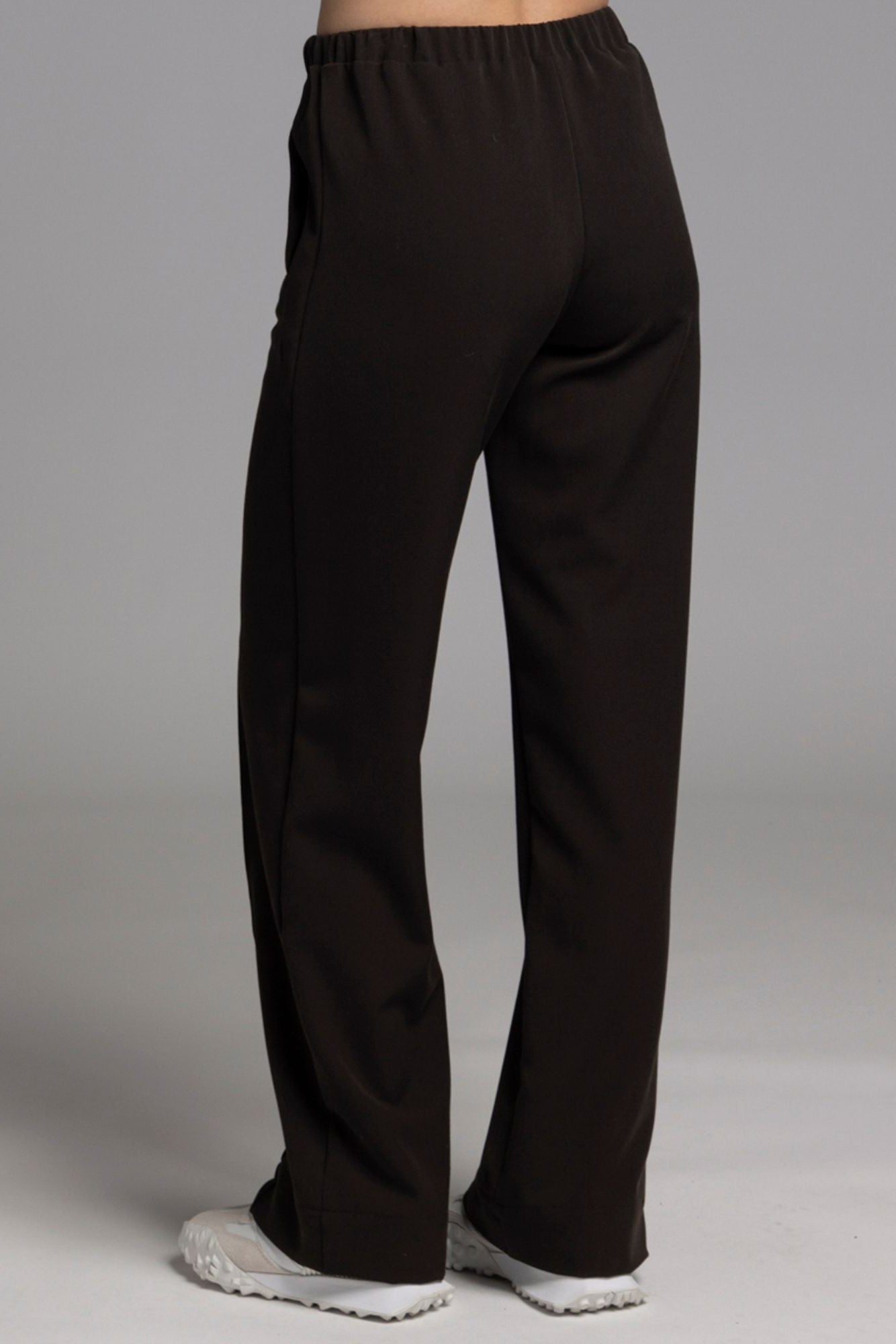 The NES Ginnie Pant is a stylish update to our top-selling Gin Pants, now featuring a pin stitch pleat down the front legs for an elongated, flattering silhouette. With a classic cut that’s easy to dress up or down, these pants are perfect for both work and everyday wear. The centre leg pin stitch detailing adds a touch of sophistication, while the flat front and covered elasticated back provide a comfortable, secure fit. The flattering angled panel at the front enhances the shape, and the full-length strai