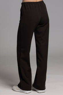 The NES Ginnie Pant is a stylish update to our top-selling Gin Pants, now featuring a pin stitch pleat down the front legs for an elongated, flattering silhouette. With a classic cut that’s easy to dress up or down, these pants are perfect for both work and everyday wear. The centre leg pin stitch detailing adds a touch of sophistication, while the flat front and covered elasticated back provide a comfortable, secure fit. The flattering angled panel at the front enhances the shape, and the full-length strai