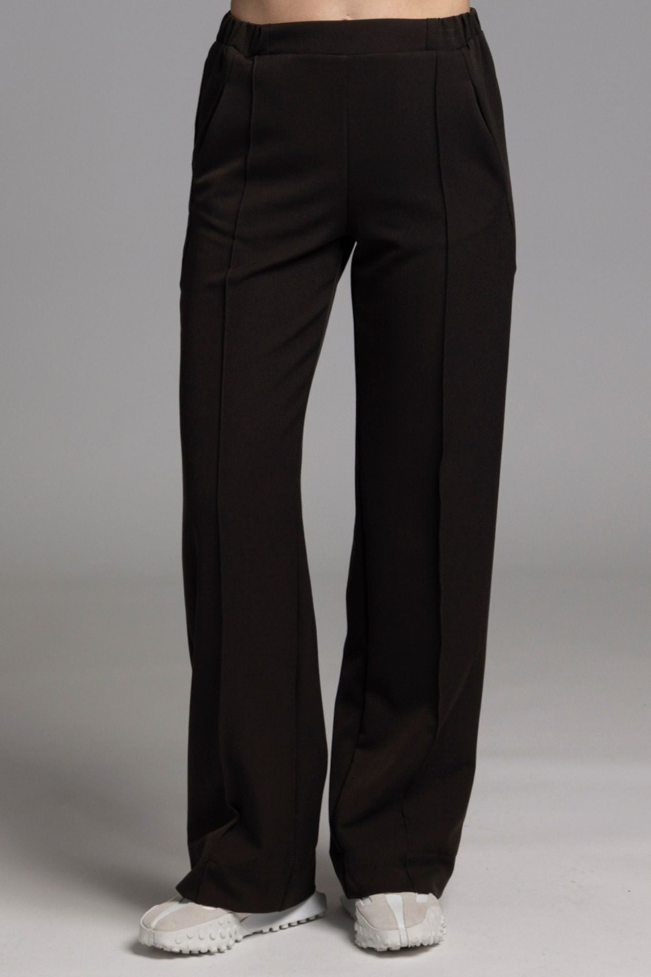 The NES Ginnie Pant is a stylish update to our top-selling Gin Pants, now featuring a pin stitch pleat down the front legs for an elongated, flattering silhouette. With a classic cut that’s easy to dress up or down, these pants are perfect for both work and everyday wear. The centre leg pin stitch detailing adds a touch of sophistication, while the flat front and covered elasticated back provide a comfortable, secure fit. The flattering angled panel at the front enhances the shape, and the full-length strai