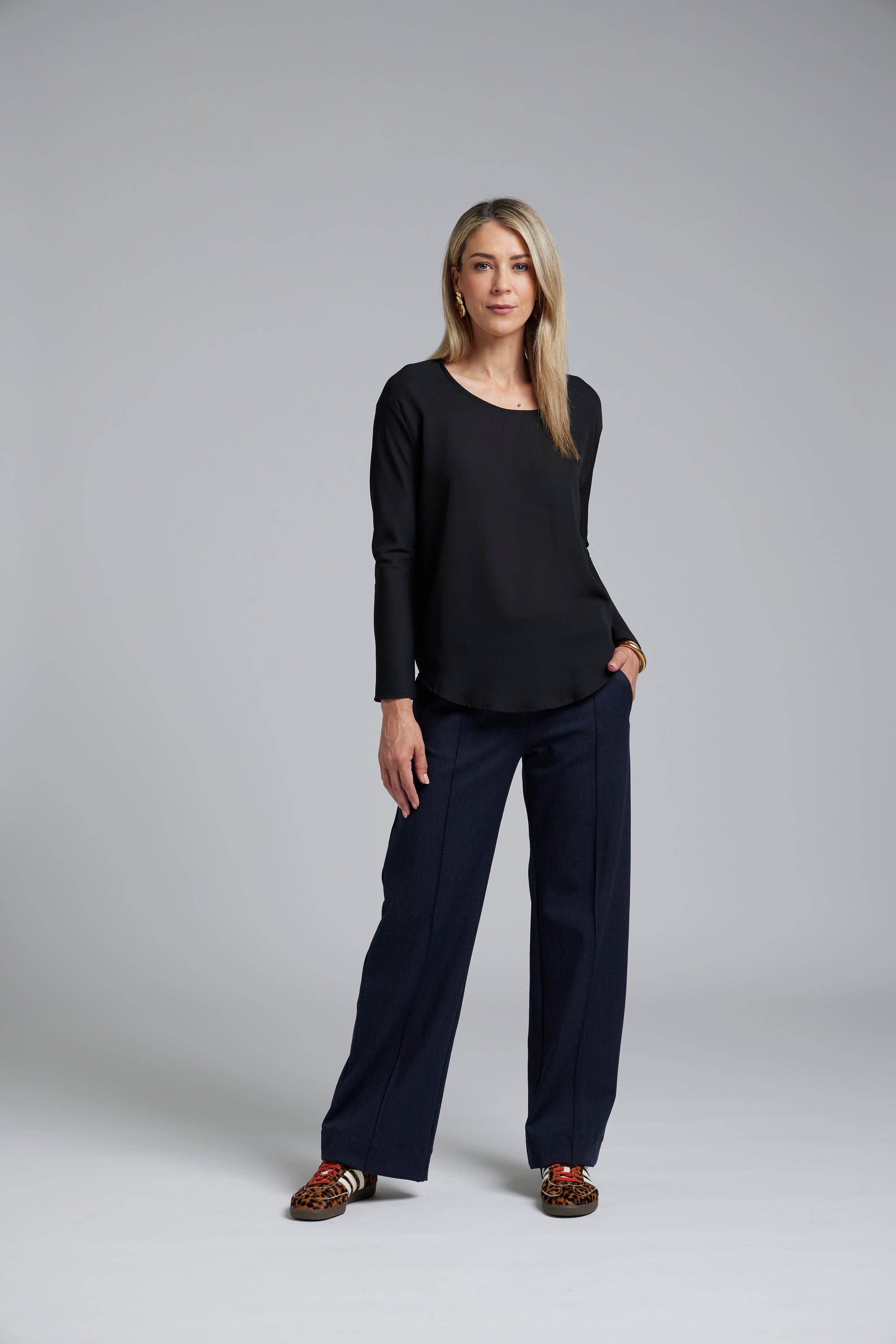 N-E-S Ginnie Pants, designed and made in NZ – women’s tailored pull-on pants with flat front, elasticated back waistband, angled side pockets, and centre front pin stitch on each leg; available in two-way stretch Latte or structured wool-Lycra Navy for polished everyday comfort.