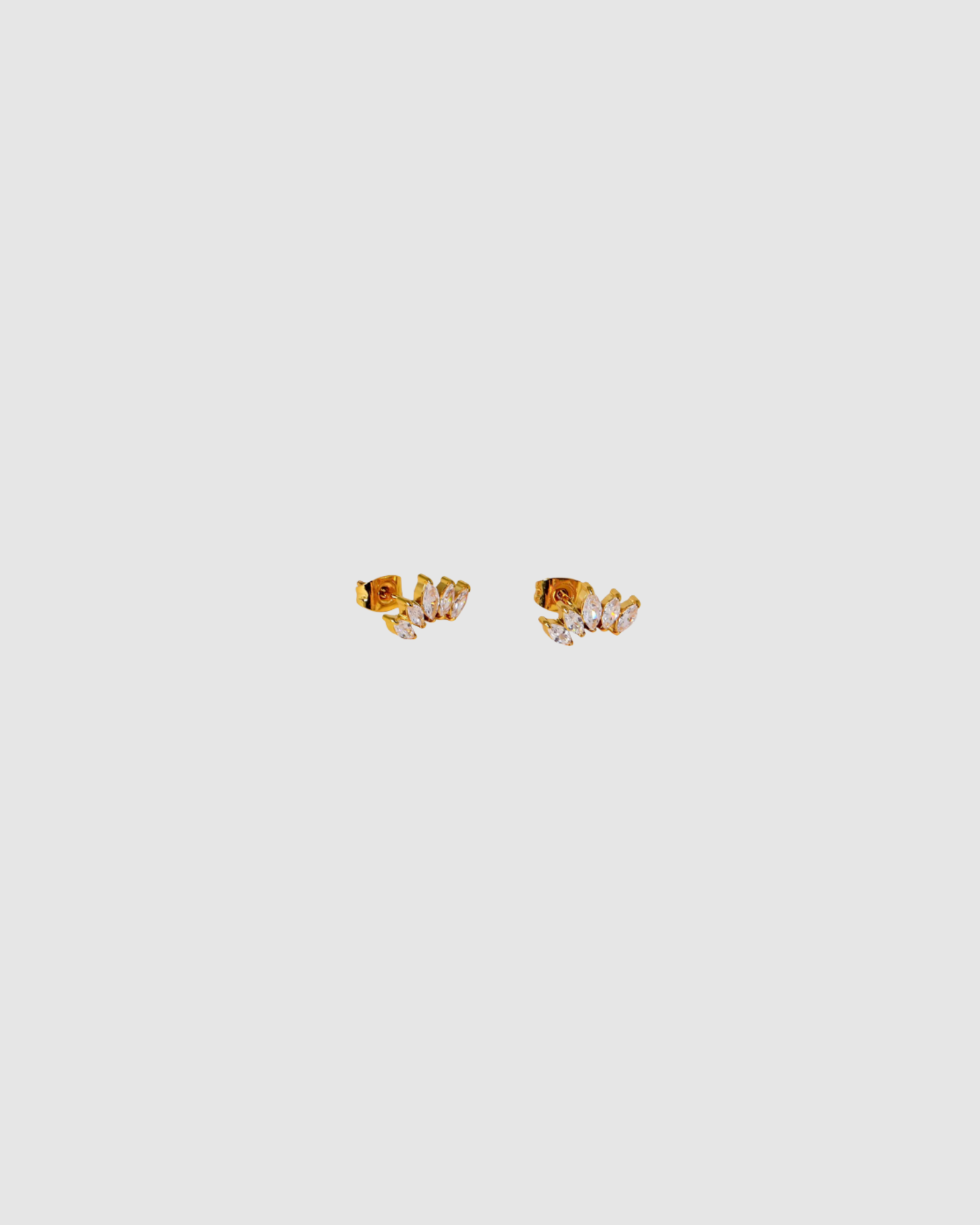Grace Earrings by Castel & Co are gold-plated stainless steel stud earrings featuring a delicate zircon detail for a subtle, refined shine. Designed to catch the light without overpowering the look, making them ideal for everyday wear or layering. Measuring 0.5 x 1.2 cm with a secure stud closure. Waterproof and hypoallergenic.