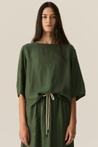 Made from our bestselling cupro blend, the POL Henri Tee has a vintage inspired silhouette in a modern fabrication.

-Wide round neckline with topstitch detailing - flat at the front with gathering over the shoulders and back.
-Pull on style.
-Full sleeves designed to sit just below the elbow.
-Relaxed fit through the body - designed to be worn unfitted.