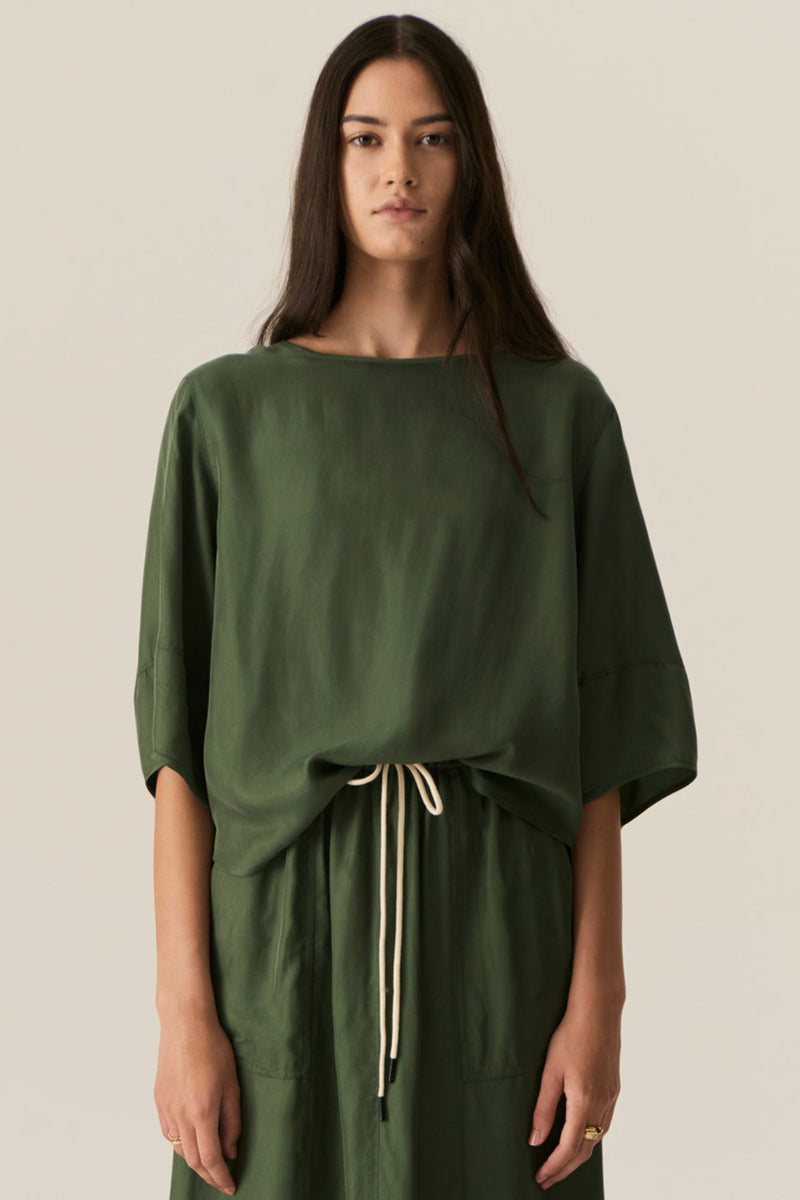 Made from our bestselling cupro blend, the POL Henri Tee has a vintage inspired silhouette in a modern fabrication.

-Wide round neckline with topstitch detailing - flat at the front with gathering over the shoulders and back.
-Pull on style.
-Full sleeves designed to sit just below the elbow.
-Relaxed fit through the body - designed to be worn unfitted.