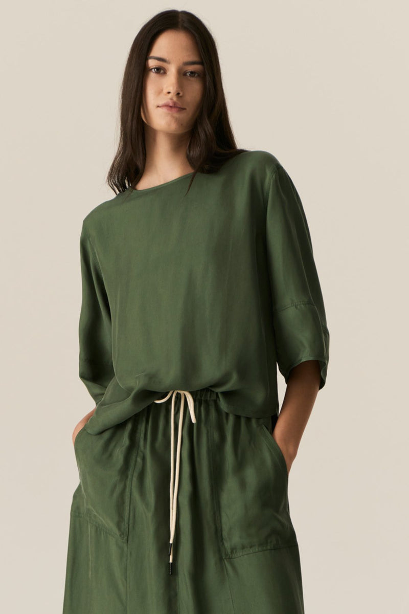 Made from our bestselling cupro blend, the POL Henri Tee has a vintage inspired silhouette in a modern fabrication.

-Wide round neckline with topstitch detailing - flat at the front with gathering over the shoulders and back.
-Pull on style.
-Full sleeves designed to sit just below the elbow.
-Relaxed fit through the body - designed to be worn unfitted.
