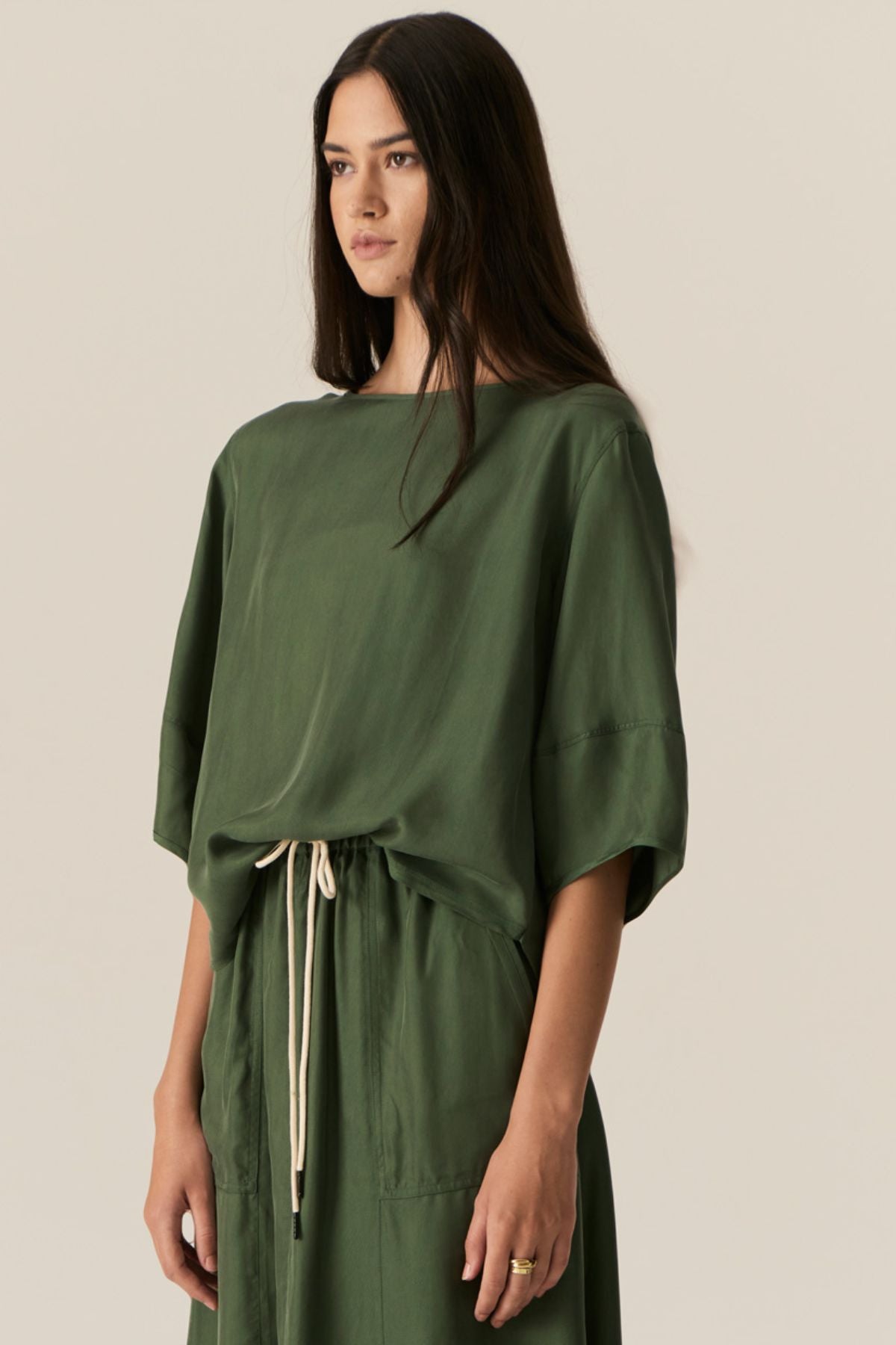 Made from our bestselling cupro blend, the POL Henri Tee has a vintage inspired silhouette in a modern fabrication.

-Wide round neckline with topstitch detailing - flat at the front with gathering over the shoulders and back.
-Pull on style.
-Full sleeves designed to sit just below the elbow.
-Relaxed fit through the body - designed to be worn unfitted.