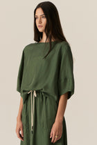Made from our bestselling cupro blend, the POL Henri Tee has a vintage inspired silhouette in a modern fabrication.

-Wide round neckline with topstitch detailing - flat at the front with gathering over the shoulders and back.
-Pull on style.
-Full sleeves designed to sit just below the elbow.
-Relaxed fit through the body - designed to be worn unfitted.