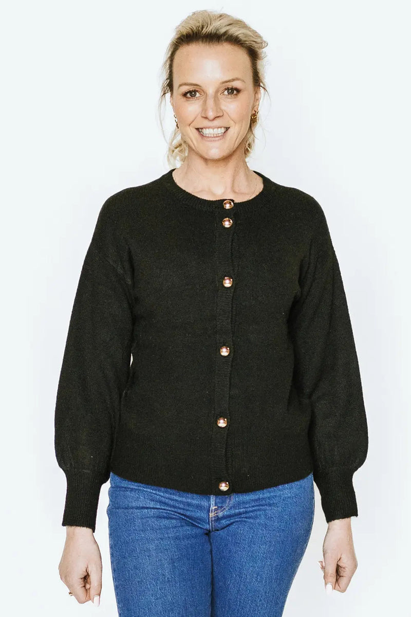 The Hilary Cardigan is your ultimate go-to layering piece, offering a super-soft feel and a relaxed fit for all-day comfort. Designed with versatility in mind, it’s the perfect balance of cosy and polished, making it an essential addition to your wardrobe. Featuring a ribbed placket and hem, the Hilary is elevated with pale gold domed buttons, adding a touch of understated sophistication. Whether you're lounging at home, heading to the café, or layering it over your favourite outfit for a polished casual lo