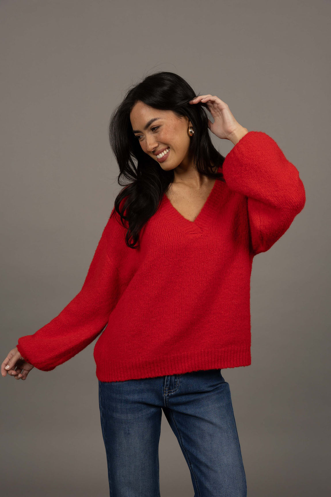 Humidity Lifestyle Nouveau V Neck Jumper in a soft wool blend, featuring a relaxed, oversized fit with a low V-neckline and subtle bell sleeves. Designed with ribbed cuffs and hem that sit just below the hips, this plush, lightweight jumper has a gentle, fluffy texture ideal for layering over denim or dresses.
