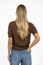 Humidity Lifestyle Aurora Top in chocolate and deep sea, crafted from a lightweight knit with a soft drape, high neckline, and relaxed short sleeves. Features ribbed cuffs and hem for subtle structure, creating a versatile transeasonal style that can be worn loose or tucked, styled casually with denim, or dressed up with tailored pieces.